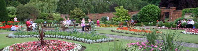 Gladstone park image of flowers and people sitting on benches