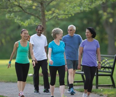 Group of seniors walking in green space