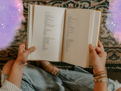 woman holding a book with purple glitter clouds