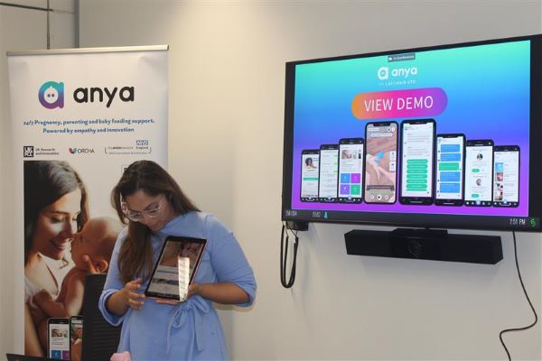 anya app representative holding iPad and demonstrating the app