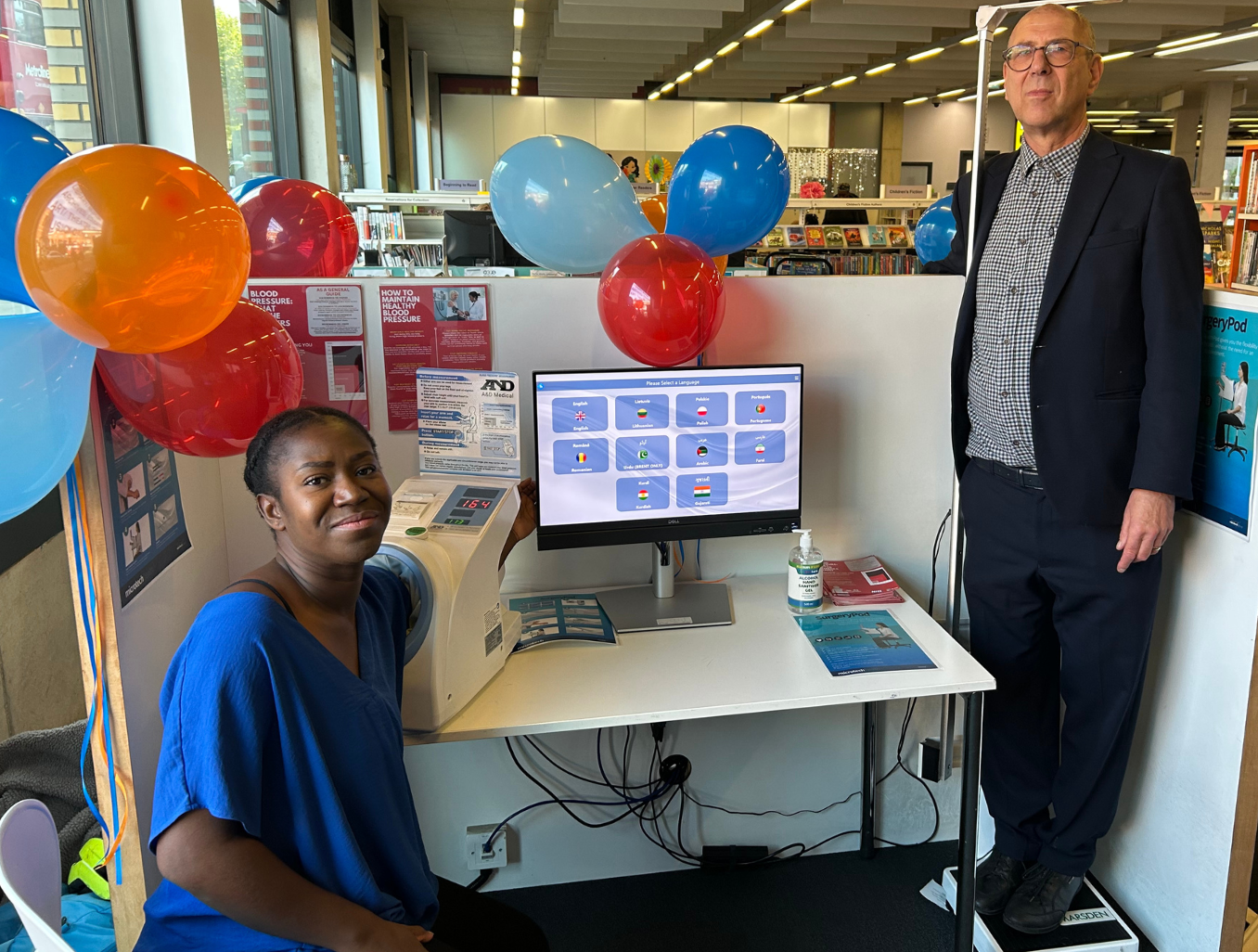 Cllr Neil Nerva and a Brent resident test out the Community Health Pod in Willesden Green Library