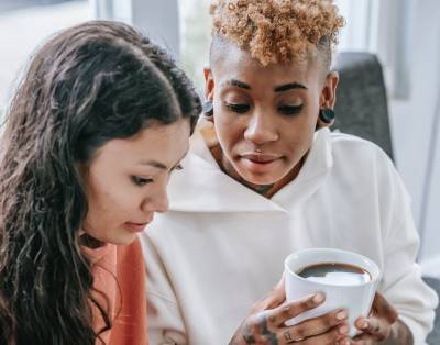 Two people in house drinking coffee