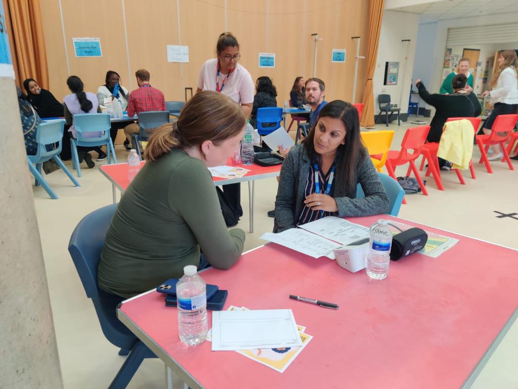 Resident and doctor having discussion at health event