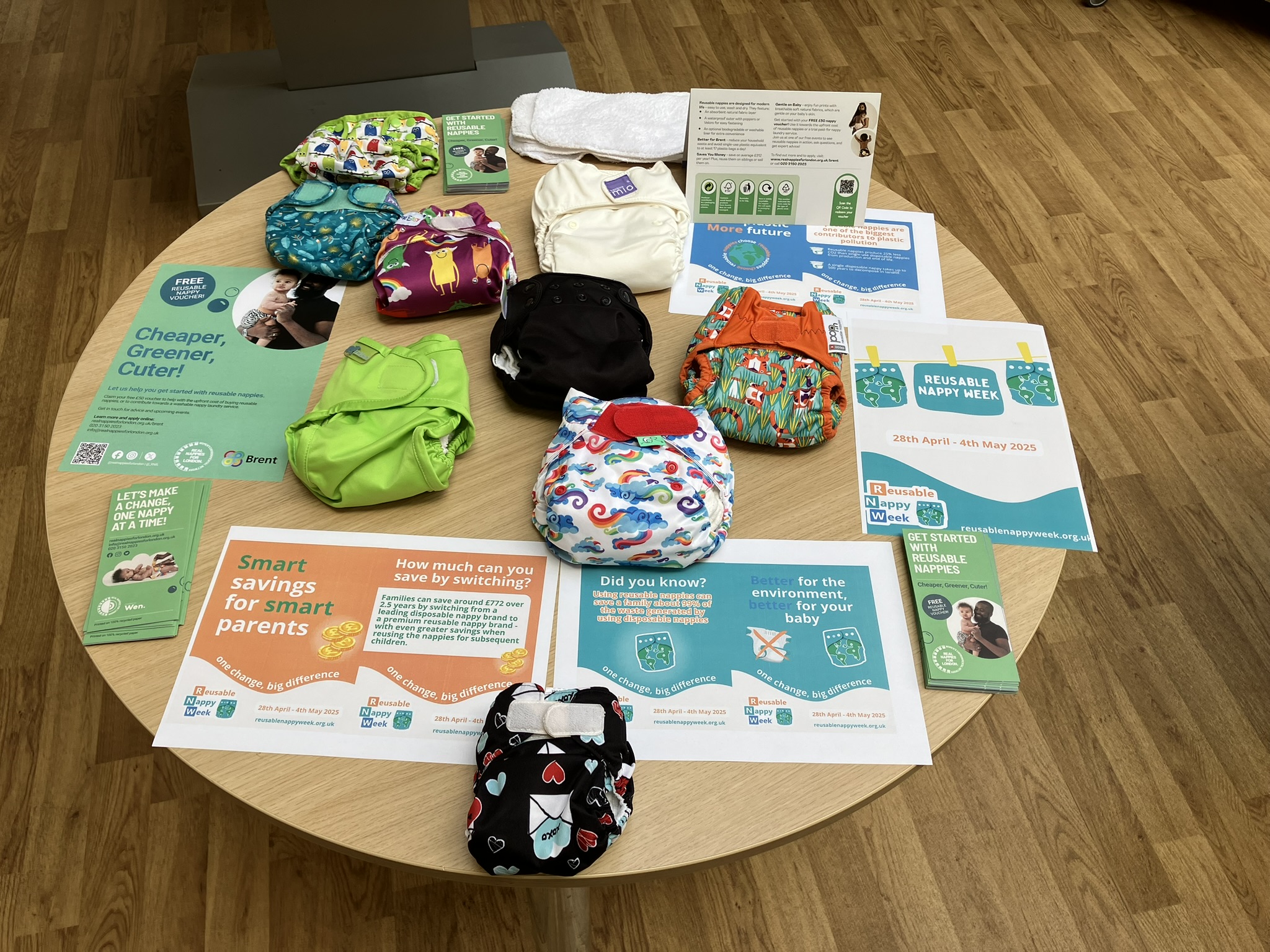 photo of a table with reusable nappies and information material