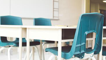 image of a white desk with blue chairs