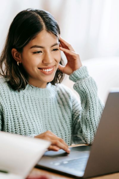 Woman at laptop smiling